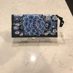 Embroidered floral black clutch.